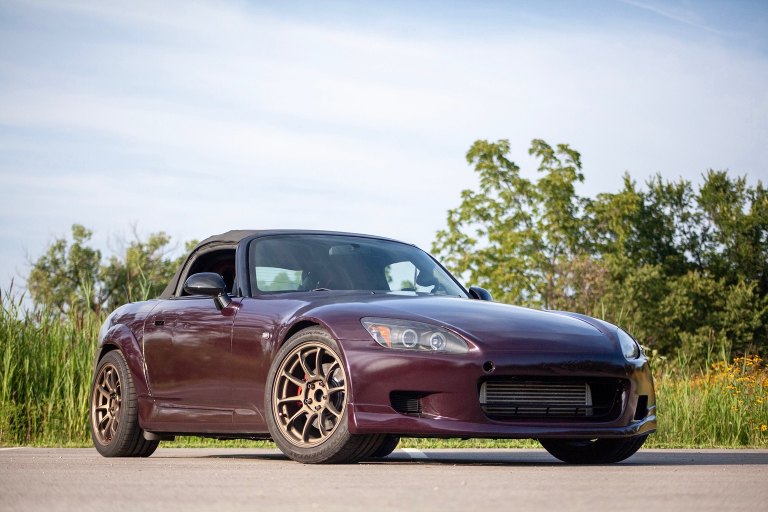 Purple Honda S2000 from the front three-quarter angle